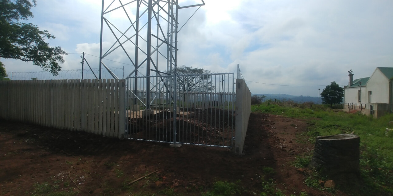Concrete palisade fencing with a matching gate — a completed Verulam Fencing job.